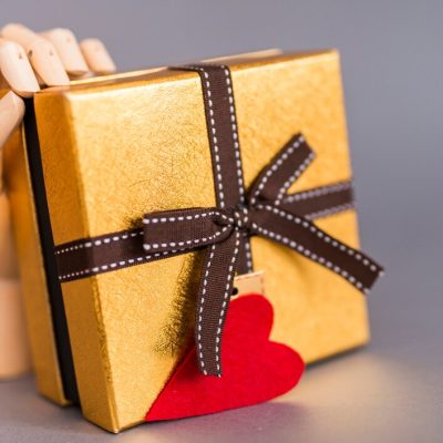 wooden-hand-holding-gift-box-with-heart_23-2148017717